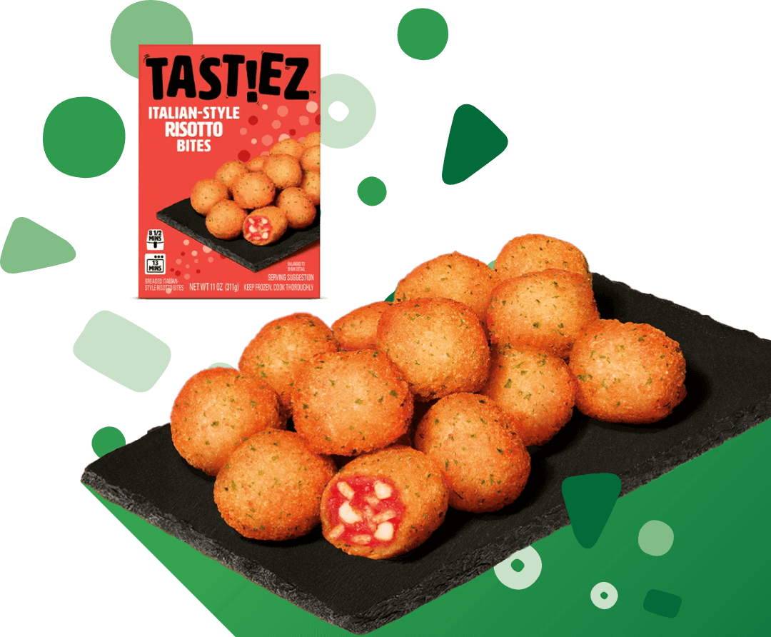 Tastiez Italian-style risotto bites arranged on a black slate plate with one bite cut open showing a tomato and cheese filling, alongside the product packaging.